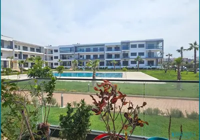 a view of a large apartment building with a pool at Escapade océane à El Mansouria in Mansouria