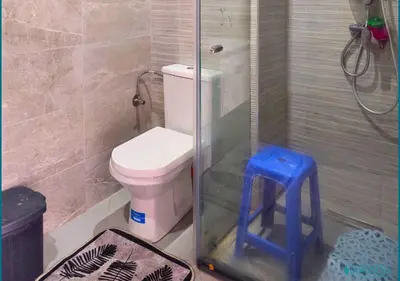 a bathroom with a shower with a toilet and a stool at Escapade océane à El Mansouria in Mansouria