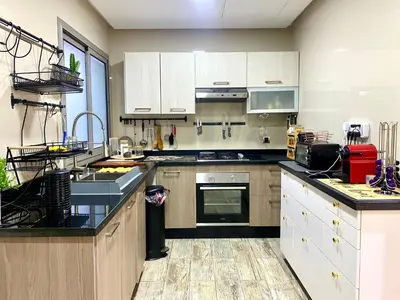 a kitchen with white cabinets and a stove top oven at Stunning Views & Prime Location! in Casablanca