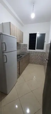 a kitchen with a white refrigerator and a stove at Appartement situated 10 min from city center in Settat