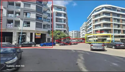 a city street with cars parked in front of buildings at Design 1BR Living Home M5 Stadium Balcony & Private Parking in Maarif