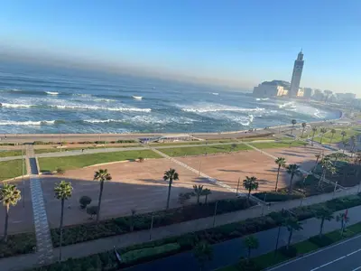 a view of the ocean and a beach with palm trees at casablanca,bourgogne,corniche in Casablanca