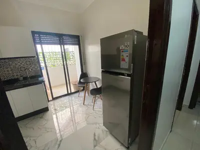 a kitchen with a refrigerator and a table and chairs at casablanca,bourgogne,corniche in Casablanca