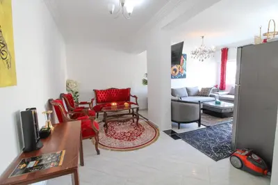 a living room with red chairs and a couch at Studio Panoramique, Mosquée Hassan II, Cœur de la Médina in Casablanca