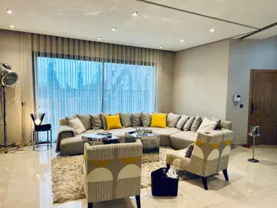 a large living room with a couch and chairs at Villa Bahia Golf beach - Bouznika in Casablanca