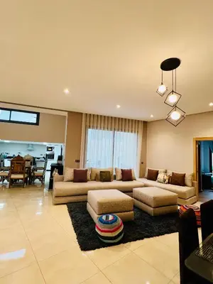 a living room with two couches and a dining room at Villa Bahia Golf beach - Bouznika in Casablanca