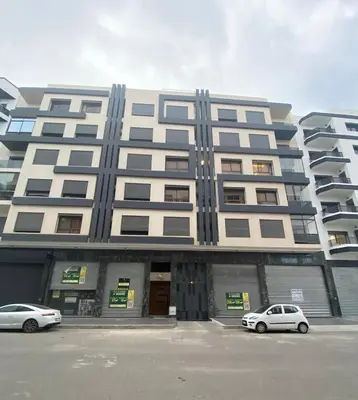 two cars parked in a parking lot in front of a building at 1 bed with balcony near CFC in Casablanca
