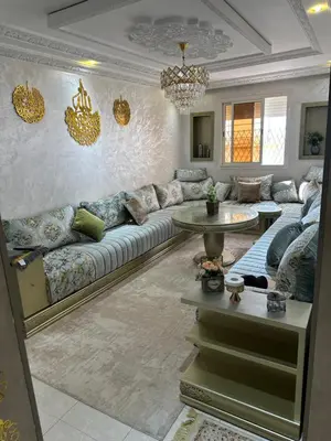 a living room with a couch and a table at Ahmed 205 in Temara
