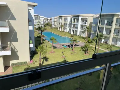 a view of a pool from a balcony of a building at Casabay SidiRahal Appartement à louer in Sidi Rahal