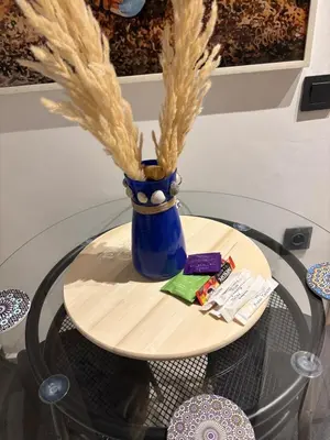 a glass table with a blue vase on top of it at nouveau penthouse en plein centre de casa in Casablanca