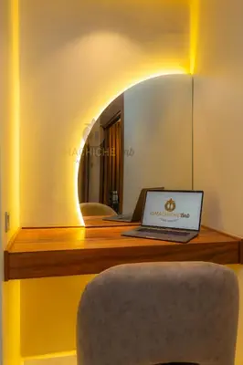 a laptop sitting on a desk with a mirror at Butterfly 703 Harve de paix au Cœur de Casablanca in Casablanca