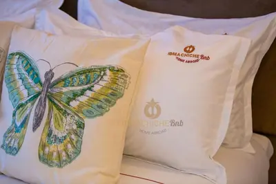 two pillows with a butterfly painted on them on a bed at Butterfly 703 Harve de paix au Cœur de Casablanca in Casablanca