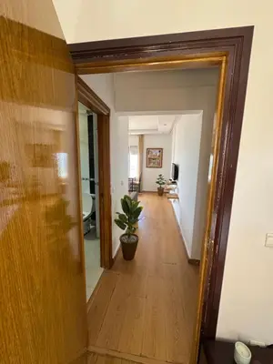 a hallway leading into a living room with a mirror at Housse moderne Versailles in Rabat