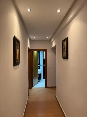 a hallway with two pictures on the walls of a room at Housse moderne Versailles in Rabat