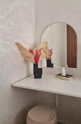 a white shelf with a vase of flowers and a mirror at Cosy Stay 15min from Casablanca Airport, in Berrechid in Berrechid