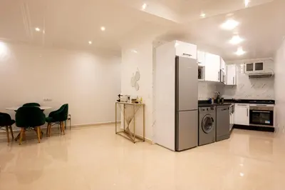 a kitchen with a refrigerator and a table and chairs at Appartement Cosy Casablanca in Casablanca