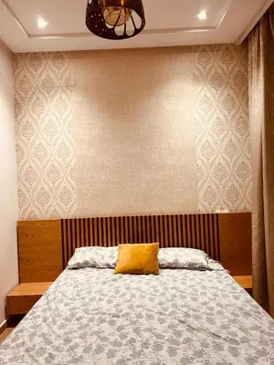 a bedroom with a bed with a yellow pillow on it at W&M LUXOR residence TEMARA in Temara