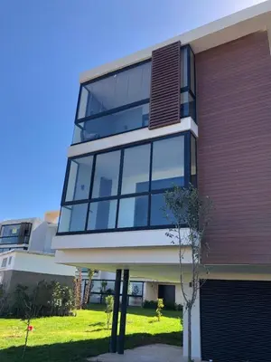 a building with glass windows on the side of it at Appartement Sidi Rahal Oceanic in Sidi Rahal