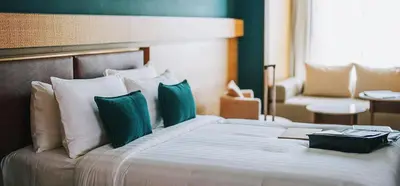 a bedroom with a large bed with green and white pillows at fresh in Casablanca