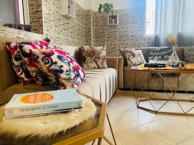 a living room with a couch with a book on a table at Le belvédère in Casablanca