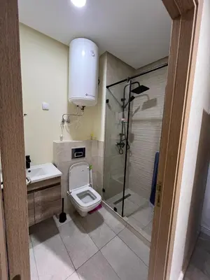 a bathroom with a toilet and a shower at Ocean park zenata in Aïn Harrouda