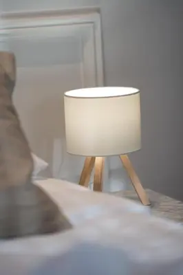 a lamp sitting on a table in a room at Central Cozy & Great Location with 2 Balconies Fast Wifi 2 Minutes to KFC Mcdo Bd 2 Mars in Casablanca