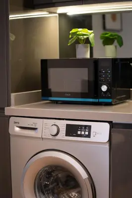 a microwave sitting on top of a washing machine at Central Cozy & Great Location with 2 Balconies Fast Wifi 2 Minutes to KFC Mcdo Bd 2 Mars in Casablanca