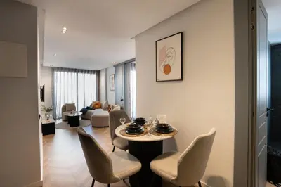 a living room with a table and chairs at Central Cozy & Great Location with 2 Balconies Fast Wifi 2 Minutes to KFC Mcdo Bd 2 Mars in Casablanca