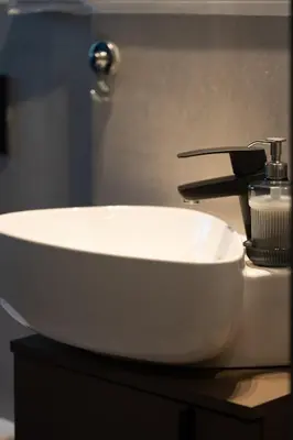 a white sink sitting on a counter in a bathroom at Central Cozy & Great Location with 2 Balconies Fast Wifi 2 Minutes to KFC Mcdo Bd 2 Mars in Casablanca