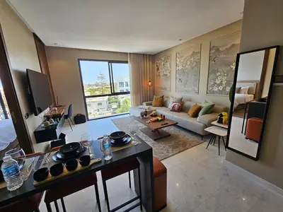 a living room with a couch and a table at Central Luxurious & Great Location Ultra Fast Wi-Fi In The Heart Of Casablanca Oasis Disrict With A City View in Casablanca