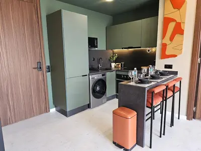 a kitchen with a stove and a washing machine at Central Luxurious & Great Location Ultra Fast Wi-Fi In The Heart Of Casablanca Oasis Disrict With A City View in Casablanca