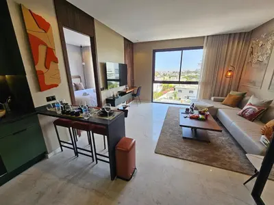 a living room with a couch and a table at Central Luxurious & Great Location Ultra Fast Wi-Fi In The Heart Of Casablanca Oasis Disrict With A City View in Casablanca