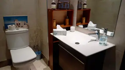 a bathroom with a sink and a toilet and a mirror at Bel appartement in Mohammedia