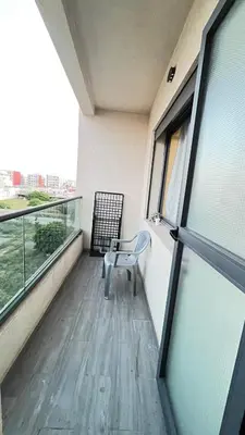 a balcony with a chair and a window at Zahira New Luxury Near The Beach - Entire Apartment in Casablanca