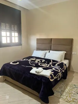 a bedroom with a large bed with towels on it at Longement moderne à Rabat in Rabat