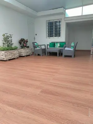 a large room with a wooden floor and chairs at Charming apartment agdal rabat in Rabat