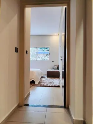 a hallway with a door leading to a bedroom at Charming apartment agdal rabat in Rabat