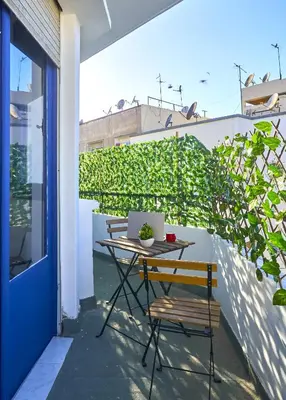 a table with a laptop on it on a balcony at Suite BD ANFA - Queen Bed & Private Balcony in Casablanca