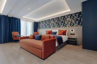 a hotel room with a bed and a couch at Exe Casablanca in Casablanca