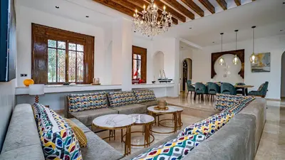 a living room with a couch and a table at Domaine Terra Cotta - Villa de luxe avec piscine sans vis-à-vis in Souk el Had