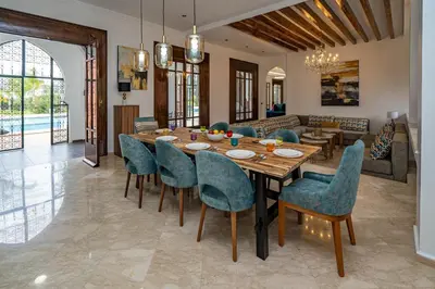 a dining room with a table and chairs at Domaine Terra Cotta - Villa de luxe avec piscine sans vis-à-vis in Souk el Had