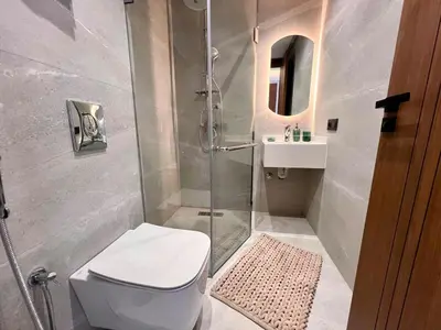 a bathroom with a shower and a toilet and a sink at Ain Diab Ocean Breeze & Parking in Casablanca