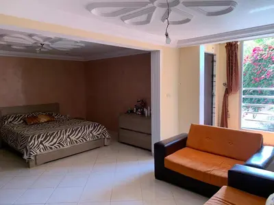 a bedroom with a bed and a couch at familly house in Tamaris