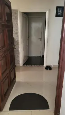 a hallway with a door and a rug on the floor at Cozy home in a good location in Mohammedia