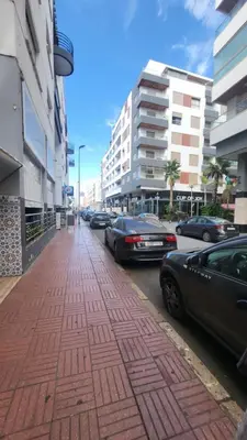 a street with cars parked on the side of the road at Cozy home in a good location in Mohammedia