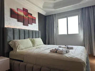 a bedroom with a bed with two towels on it at Wifaq temara in Temara