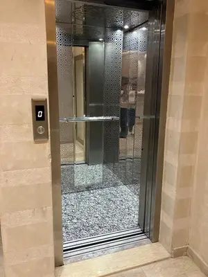 a glass door with a shower in a building at Appartement lumineux près de la plage de Sidi Bouzid in El Jadida