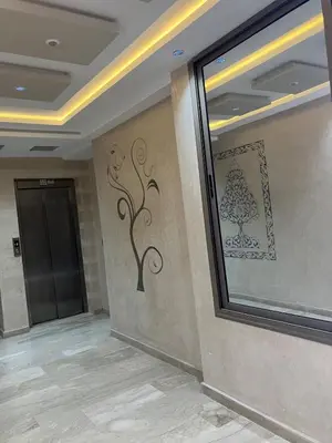 a hallway with a door and a wall with a painting on it at Appartement lumineux près de la plage de Sidi Bouzid in El Jadida