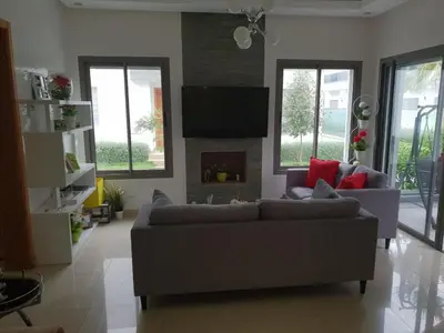 a living room with a couch and a fireplace at Villa Blanca - by Nero in Sidi Rahal