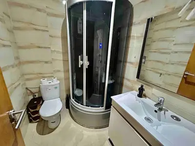 a bathroom with a shower and a toilet and a sink at Vivez le Confort Moderne et la Serennité in Rabat